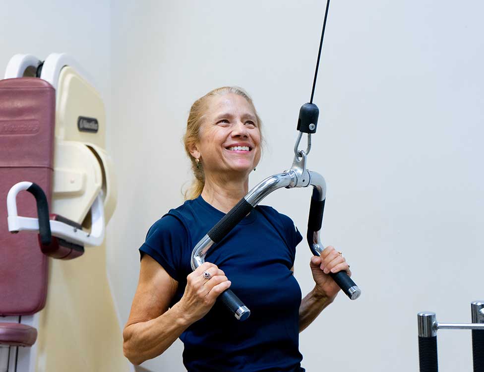 Senior woman working out at the Fitness Center at NSSC.